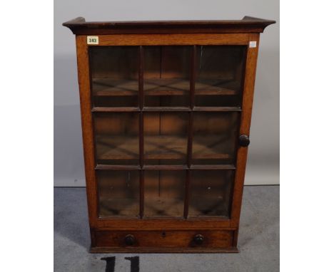 A 19th century oak hanging cupboard with panel glass door over single drawer, 58cm wide x 80cm high. 