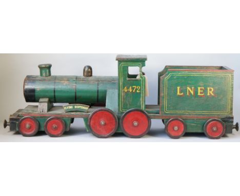 A scratch built wooden toy train, scale model, green painted, 'Flying Scotsman LNER 4472', 116cm overall. 