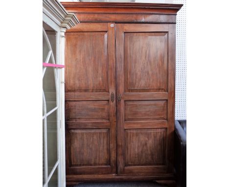 A George III mahogany breakdown wardrobe with a pair of triple panel doors, on bracket feet, 142 cm wide x 206 cm high. 