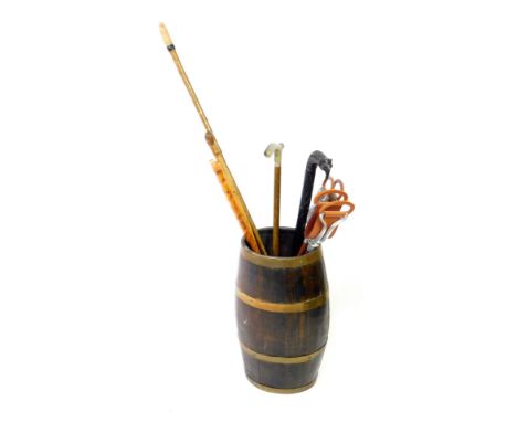 An oak and brass bound cooper's barrel, converted to a stick stand containing walking and shooting sticks, 66cm H.