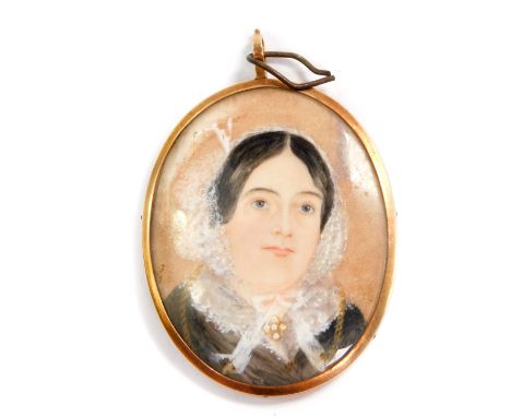 A Victorian portrait miniature of a lady, in an oval gilt metal mount, verso centred with crossed hair, within a cobalt blue 