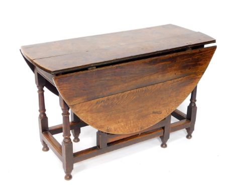 A Georgian oak gate leg dining table, raised on turned supports united by stretchers, 72cm H, 120cm W, 46cm D, 140cm extended
