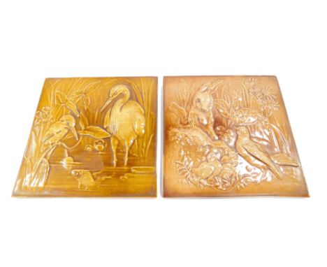 Two Burmantofts Faience late 19thC pottery tiles, one relief decorated with a heron and kingfisher in a pond, incised monogra