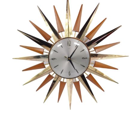 A 1970's Metamec light beech and brass sunburst wall clock, circular silvered dial bearing Arabic numerals at quarters, batte