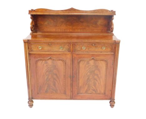 A George IV flame mahogany chiffonier, the back with a galleried small shelf, raised on s scroll supports, over two frieze dr