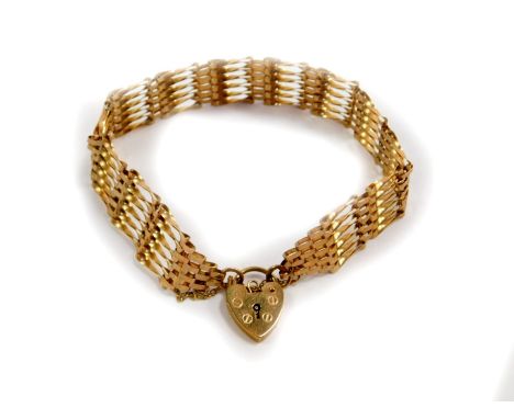 A 9ct gold six bar gate bracelet, on a heart shaped padlock clasp with safety chain as fitted, 7.2g.