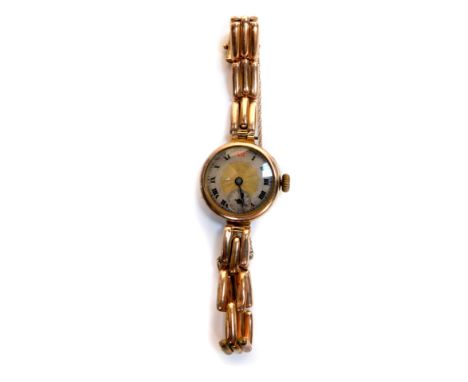A mid 20thC lady's 9ct gold cased wristwatch, circular cased with engine turned gold and silver dial, chapter ring bearing Ro
