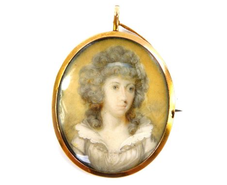 A late 18thC portrait miniature of a lady, in an oval gilt metal pendant mount, with brooch pin attachment, 48mm x 39mm.