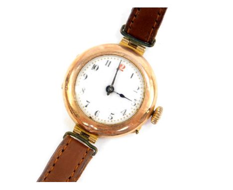 An early 20thC lady's 9ct gold circular cased wristwatch, white enamel dial bearing Arabic numerals, Swiss movement, on a lea