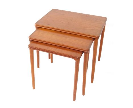 A 1970's teak nest of occasional tables, raised on cylindrical legs, largest table 49cm H, 55cm W, 40cm D.