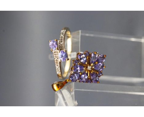 A yellow metal ring set with two tanzanites and diamond shoulders, size P together with a yellow metal pendant set with tanza