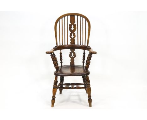 An elm and bentwood stick back chair with pierced splat over shaped arms on bobbin turned spindles, and a shaped seat, raised