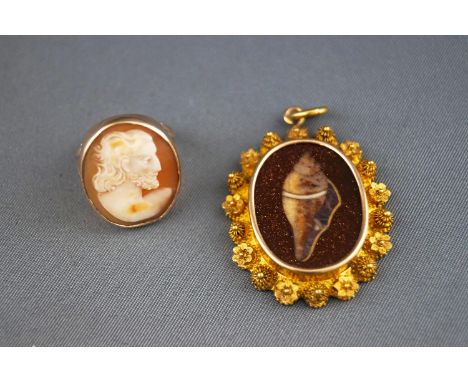 A yellow metal ring set with a carved cameo, size F, tested as 9ct gold. Together  with a yellow metal pendant having a golds