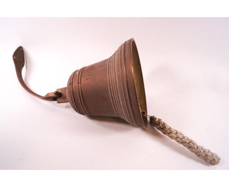 A brass door bell with hinged bracket, 22cm high