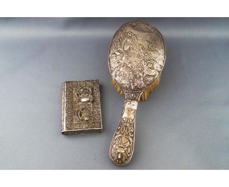 A handled hairbrush, profusely decorated with a hunting scene of the kill, Birmingham 1903, 25cm long, together with a Chines