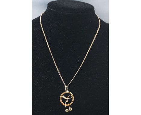 A yellow metal pendant of abstract design set with peridot and seed pearls. Suspended from a curb link chain. Untested - both