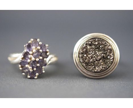 A selection of two rings, one as a tanzanite (untested) cluster ring and the other as a dress ring having iron pyrite. Untest