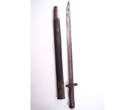 A 1907 Wilkinson steel bayonet in original scabbard, the blade stamped with a crown, 1907, Wilkinson, 57cm long (total)