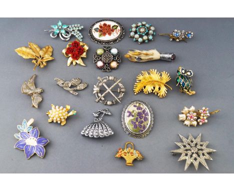 A collection of twenty costume brooches having paste stones or enamel finish. Gross weight, 239.5 grams
