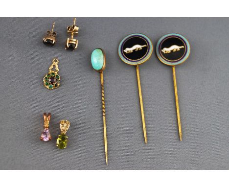 A collection of jewellery to include three stick pins, three pendants and an unmatched pair of cat's eye cabochon studs. Unte