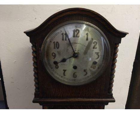 An oak grandmother clock with Westminster chime.