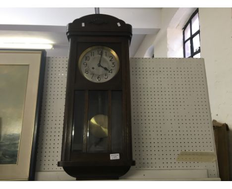 An oak glazed panel front wall clock with oak barometer and mahogany two door cabinet.