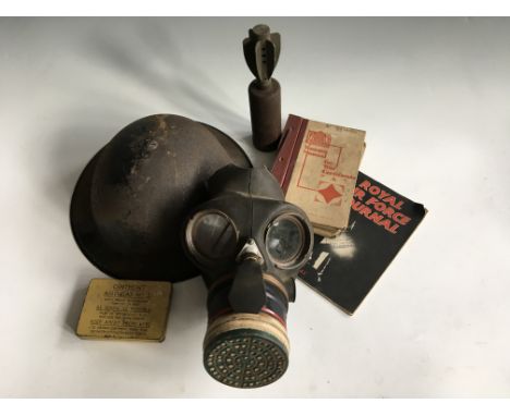 A gas mask in bag with British service helmet, mortar bomb, October 1943 Royal Air Force journal and training manual for war 