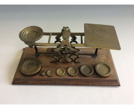An S. Mordan & Co. brass graduated postal scales on oa base with set of weights from 1/2-16 oz.