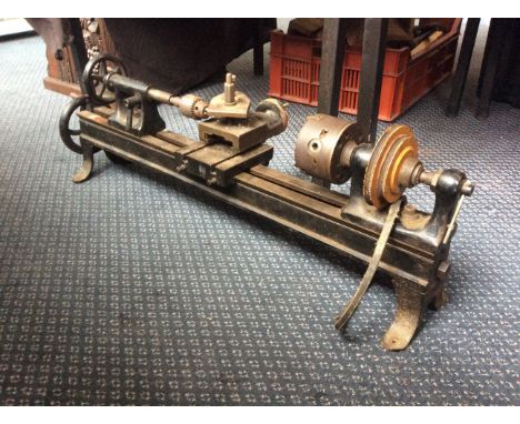 A black painted bench top turning lathe.