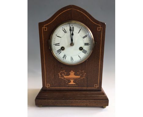 A wooden mantel clock with wooden inlay design. Height 33cm.