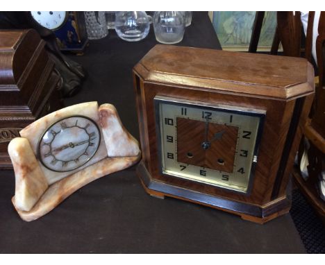 A pink marble Metamec Dereham mantel clock with a walnut mantel clock.