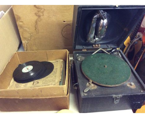 A Bush Mains Table radio, together with a Decca wind up gramophone and records.