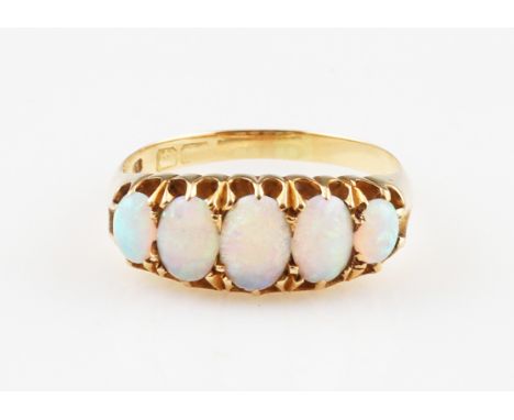 A five stone opal ring, set with five graduated oval opal cabochons, hallmark rubbed, ring size N½.