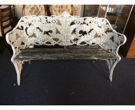 A Coalbrookdale style heavy cast iron white painted garden bench with fern leaf decoration.
