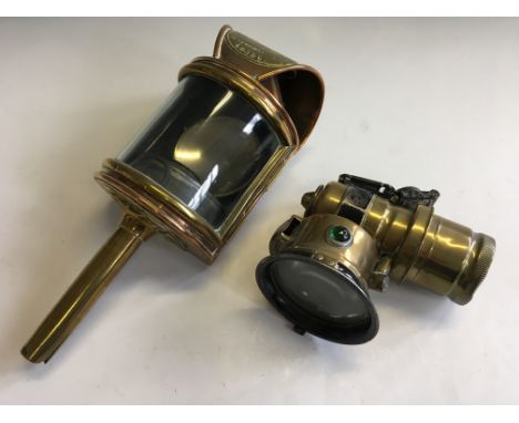 A Miller motorcycle lamp with a Shand Mason & Co. fire engine lamp.