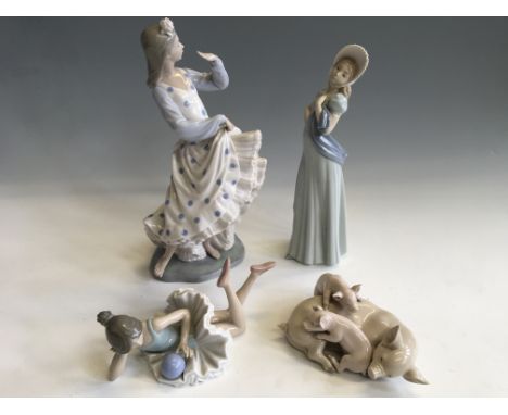 A Lladro figurine group of pig and piglets, with three Nao figurines of ballerina, flamenco dancer and lady with bonnet.