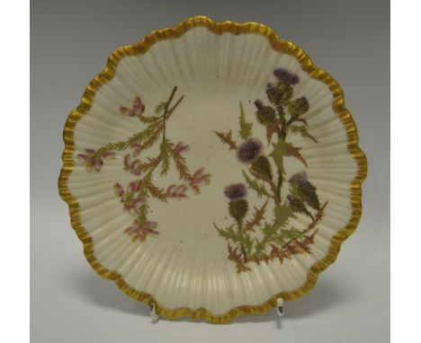 A Royal Worcester fluted shaped circular plate, printed and painted with thistles, gilt banded border, shape 1416
