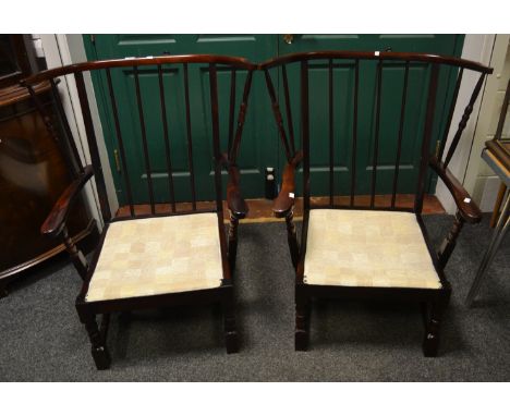 A pair of Ercol-type stained oak bowed spindle-back conservatory armchairs; a G-Plan dining chair (3)