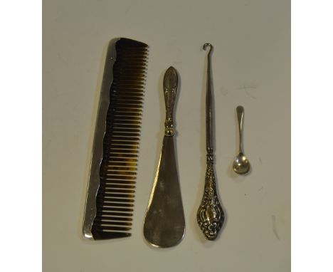 A large George V silver mounted tortoiseshell comb, Birmingham 1922; a silver salt spoon; a button hook; a shoe horn (4)