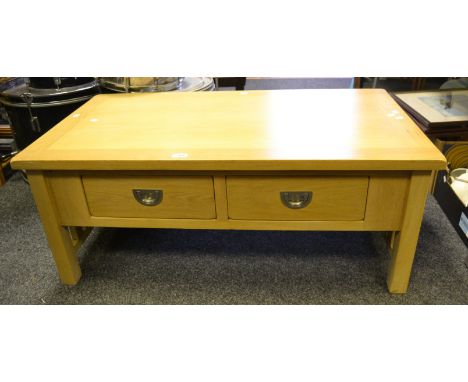 A contemporary light oak coffee table, four short drawers to frieze, chromed handles