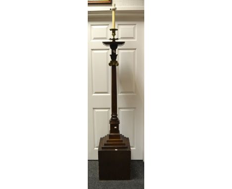 An early-20th century oak substantial standard lamp, brass fittings, above oversailing plinth top, brass-topped ionic column 