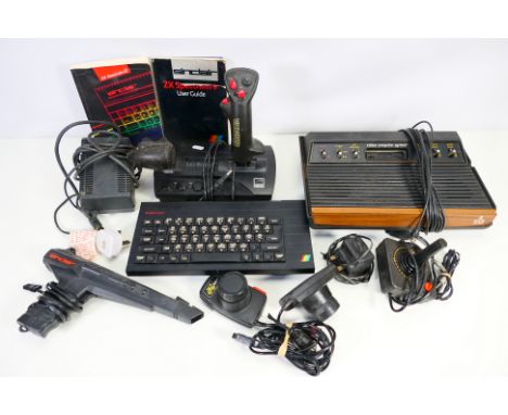 Sinclair - Atari - A vintage Sinclair ZX Spectrum + with user guide, power unit and 2 x controllers, also a Atari 2600 consol