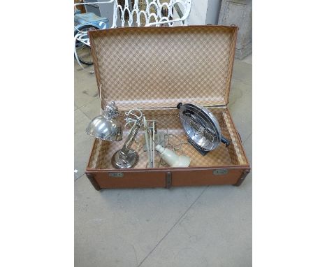 A steamer trunk, heat lamp and two anglepoise lamps
