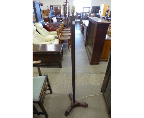 A carved wood and brass standard lamp