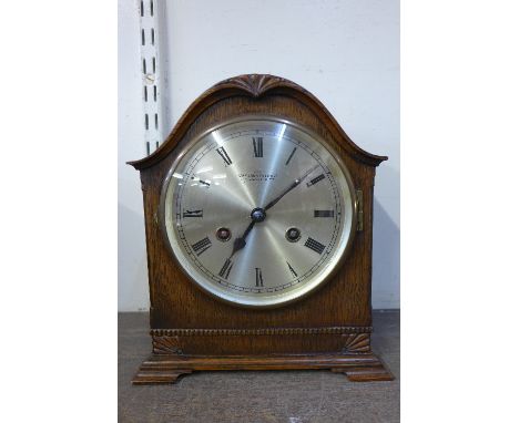 A Camerer Cuss & Co. oak mantel clock
