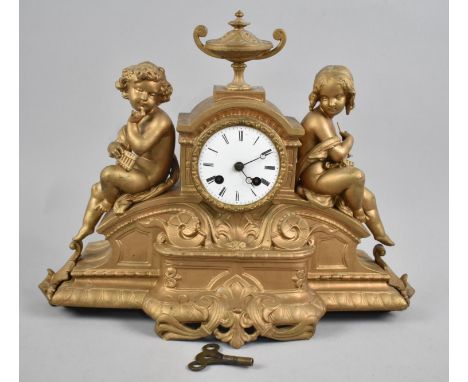 A Gilded French Bronze Figural Mantle Clock with Seated Boy and Girl Holding Musical Instruments, Movement Requires Attention