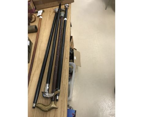 Four walking sticks to inc compass, Dolphin, Hare etc
