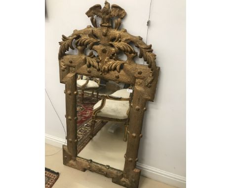 A 19th century gilt mirror with eagle finial