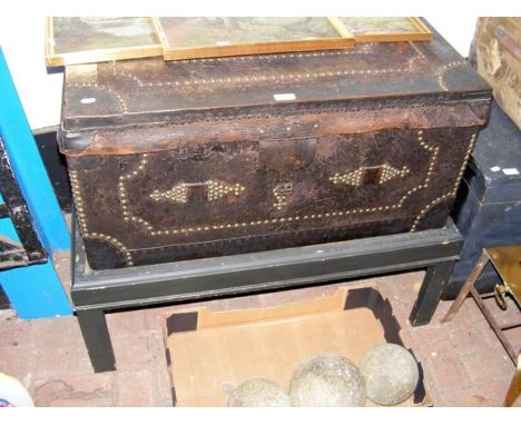 A brass studded leather clad trunk on stand 