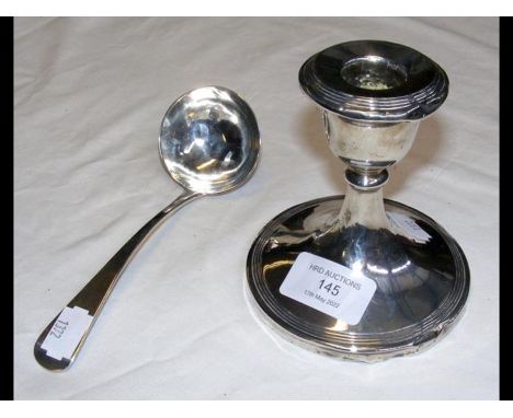 A Georgian silver ladle together with a filled silver candlestick